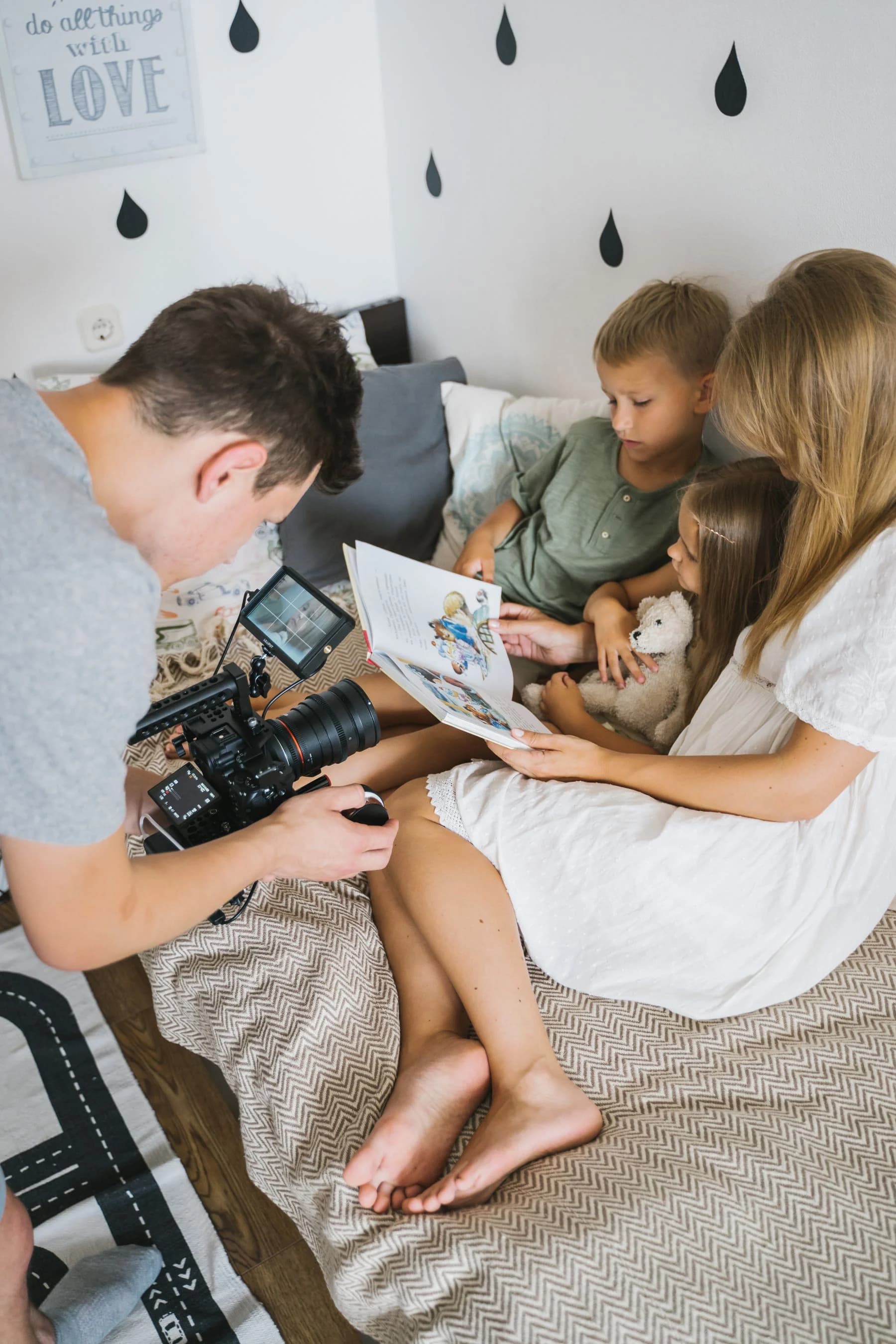 Photographer taking a family photo indoors at home