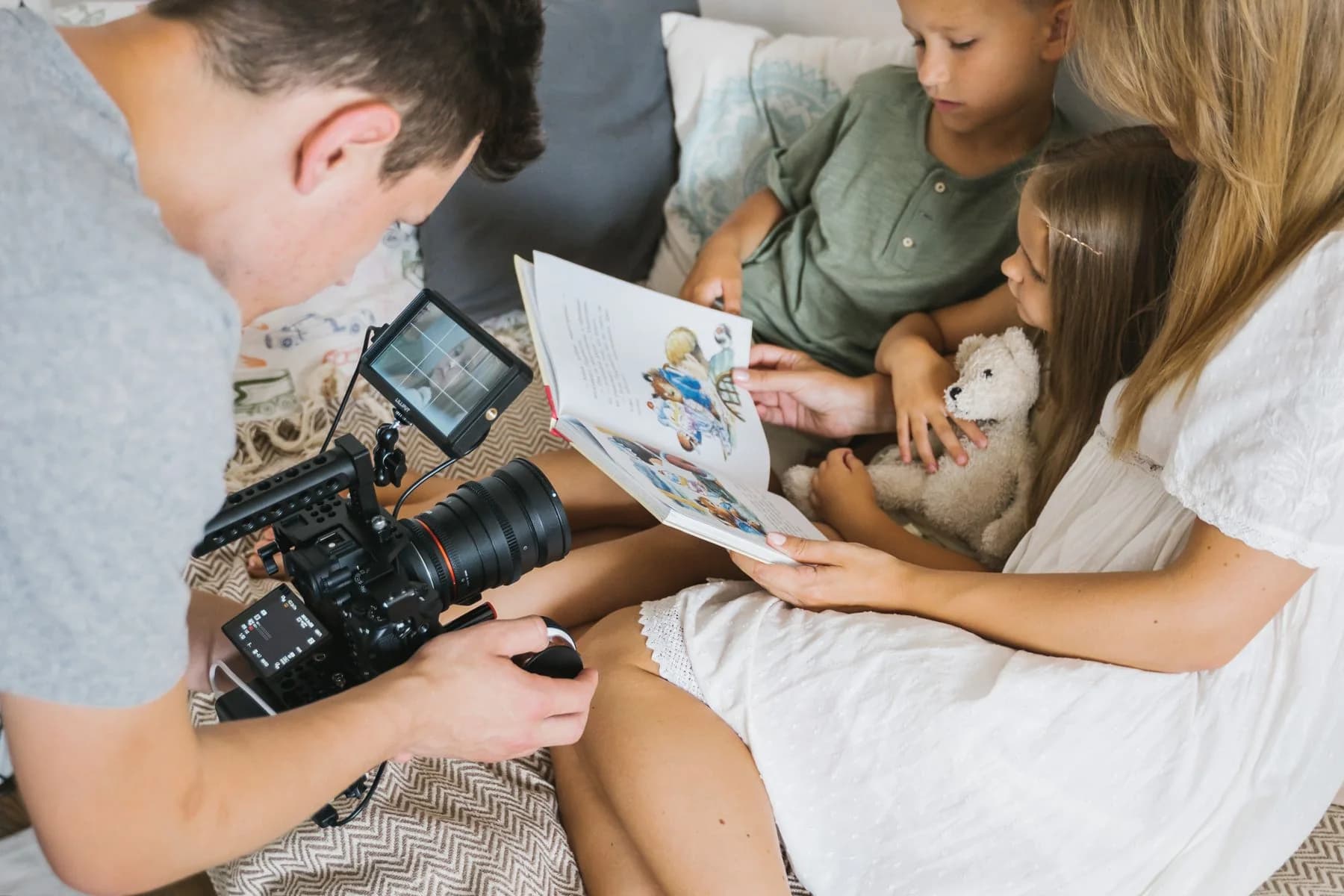 Representative stock photograph of a photographer taking an indoor family photo
